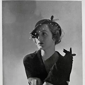 Mrs Leo d'Erlanger, studio fashion portrait in hat and gloves. With description, Mrs Leo d'Erlanger, who is an American by birth, is easily one of the most beautiful women in London to-day