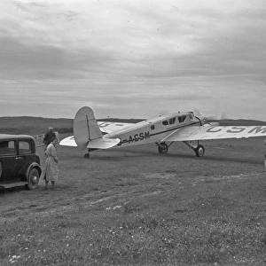 People with car and light aircraft, Scotland