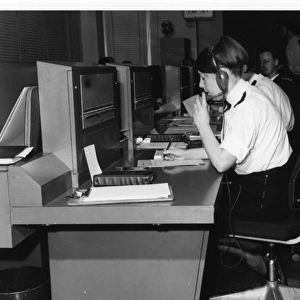 Police officers at work in communications room