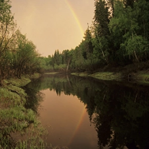 Rainbow after evening rain over river Negustyah