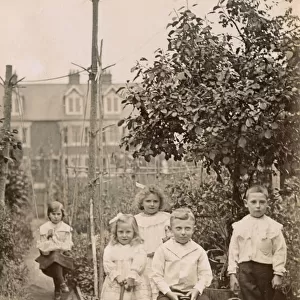 Five siblings playing in their suburban garden