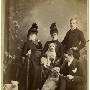 Studio portrait, family of four with three terrier dogs