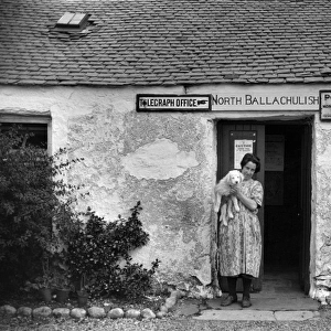 Woman and dog, North Ballachulish Post Office, Scotland