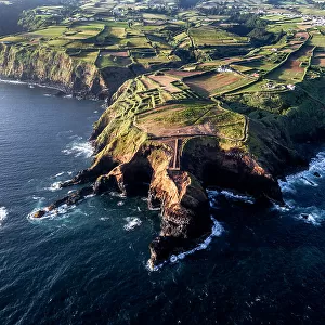 Aerial view of the coasts and cliffs of the island of Sao Miguel over the lighthouse of Farolim dos Fenais da Ajuda, Azores Islands, Portugal, Atlantic, Europe