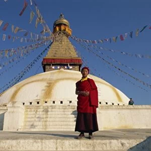 Buddhist monk in front of the largest stupa in Nepal