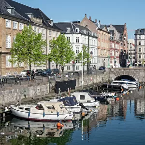 Canal under the Strombroen (Storm Bridge) with colourful houses in the old town, Copenhagen, Denmark, Scandinavia, Europe