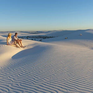 A couple enjoys White Sands National Park at sunset, New Mexico, United States of America