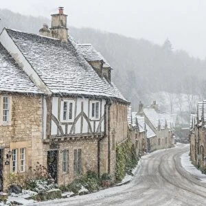 Looking down the quintessential English village of Castle Combe in the snow, Wiltshire