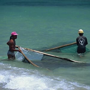 Men net fishing at Candidasa, Bali, Indonesia, Southeast Asia, Asia