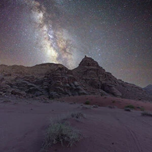 Milky Way core rising over a peak in the Wadi Rum desert, Jordan, Middle East