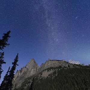 Milky way rises over the Canadian Rockies in the Yoho National Park, with moonlight