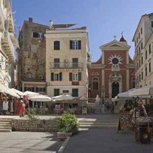 A sunny square with a church, pavement cafes, and small shops, in old Corfu. Island of Corfu, Ionian Islands, Greek Islands, Greece, Europe