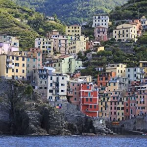 Tiny harbour and medieval houses in steep ravine, Riomaggiore, Cinque Terre, UNESCO