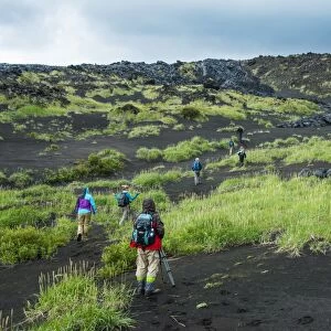 Tourists walking through the lava landscape of the Tolbachik volcano, Kamchatka, Russia, Eurasia