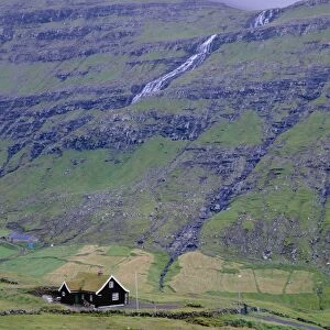 Traditional turf roofed house and hills at Saksun, Streymoy Island, Faroe Islands