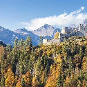 View of the old Ehrenberg Castle surrounded by colorful woods and rocky peaks, Reutte