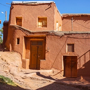 Winding lanes and donkey in 1500 year old traditional village of red mud brick houses