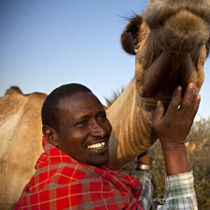 Isiolo, Northern Kenya. A traditional Somali pastoralist with a camel in his Boma