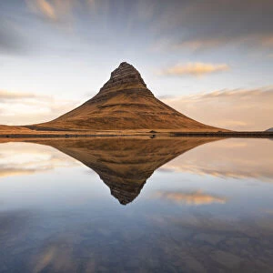 Kirkjufell mount reflected in a little lagoon during a winter sunrise, Snaefells Peninsula, Vesturland, Iceland