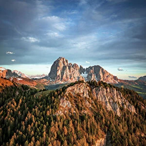 Spring woods on Sassolungo group, Sassopiatto, Gardena Valley and Seceda at sunset, aerial view, Dolomites, South Tyrol, Italy