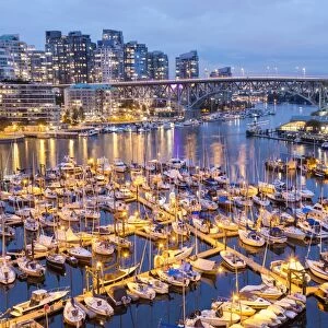 View over harbour & Granville Island with city skyline at dusk, Vancouver, British Columbia