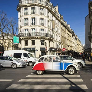 A vintage Citroen car painted in the colours of the France flag gets stuck in the