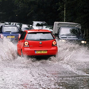 Cars driving through flash floods in Sevenoaks Kent