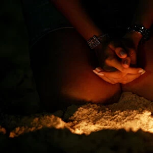 Brazilian woman prays on Copacabana beach in Rio de Janeiro