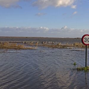 Flooded coast road and marshes after tidal surge, Cley-next-the-sea, North Norfolk, England, December 2013