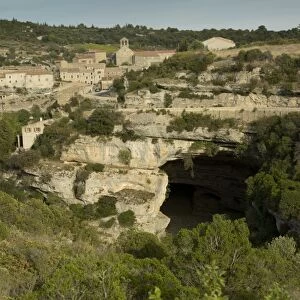 View of old village on gorge with large cave, Minerve, River Cesse Gorge, Herault, Languedoc-Roussillon, France