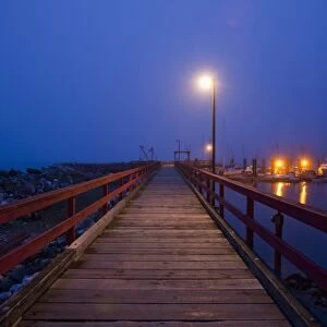 Canada, British Columbia, Hornby Island, Small boat harbor and dock at dusk in winter fog