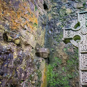 Elaborate Celtic cross marks a grave at a historic Irish church, County Mayo, Ireland