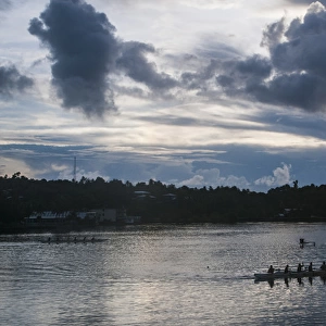 Local people training for the rowing championship in the island of Yap at sunset