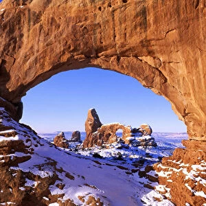 Morning light on North Window framing Turret Arch in winter, Arches National Park, Utah, USA