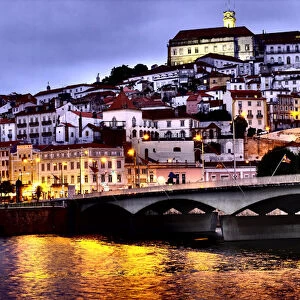Portugal, Coimbra. Old Mondego River bridge and hillside view of Old University of Coimbra
