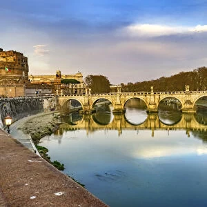 Red wall of St. Angelo Bridge, Tiber River reflection, Rome, Italy
