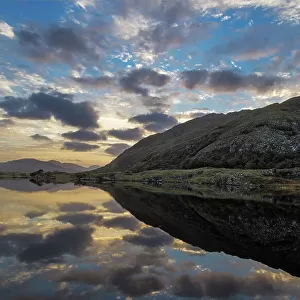 Sunset clouds reflect in Upper Lake Killarney in Killarney National Park, Ireland