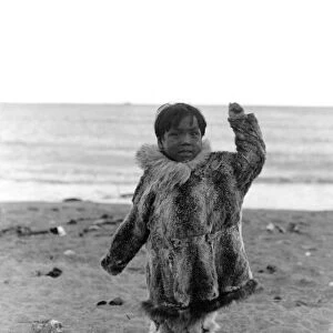 ALASKA: ESKIMO CHILD. A young Eskimo boy playing on the beach, Alaska