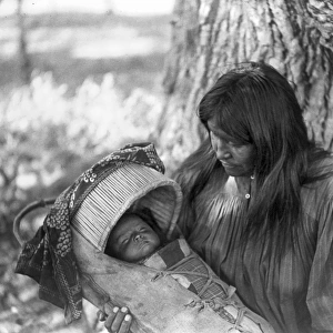 APACHE WOMAN & CHILD, c1906. An Apache woman holding an infant in a cradleboard