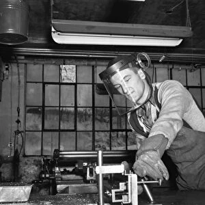 FACTORY WORKER, 1942. John Scott, a sheet metal cutter at work at the Warren McArthur