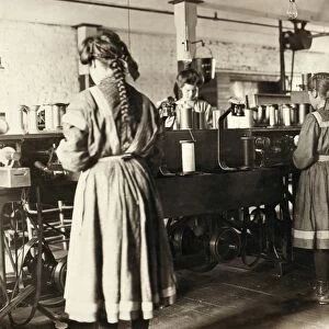 HINE: CHILD LABOR, 1909. Young girls working in the cotton spool room at the Bibbings