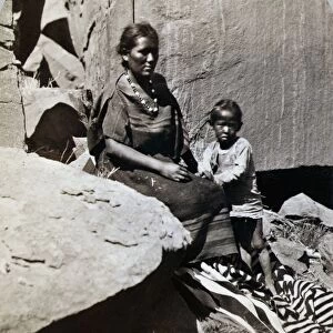 NAVAJOS, 1873. Navajo woman and her son at their home in Canyon de Chelly, Arizona