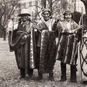 PUEBLO MEN, 1923. Pueblo men, carrying blankets and canes given to them by Abraham Lincoln