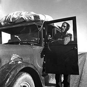 UNEMPLOYED MIGRANT, 1937. Migrant worker from Chickasaw, Oklahoma with his stalled