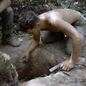 VIETNAM WAR, 1967. Sergeant Ronald Payne checking a tunnel for Viet Cong in the Ho Bo Woods