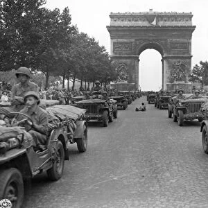 WWII: PARIS, 1944. American jeeps of the 28th Infantry Division driving down the