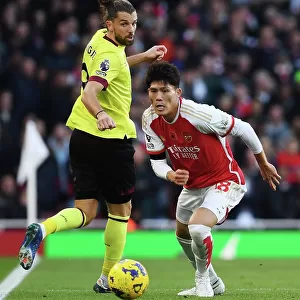 Arsenal's Tomiyasu Fends Off Burnley's Rodriguez in Premier League Clash