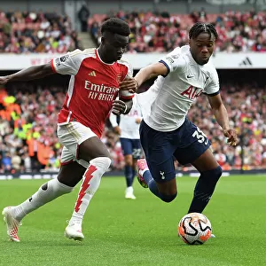 Saka vs. Udogie: Intense Rivalry Unfolds - Arsenal's Bukayo Saka Clashes with Tottenham's Destiny Udogie in the 2023-24 Premier League Showdown at Emirates Stadium