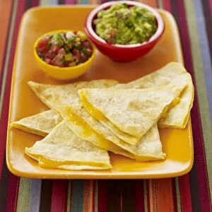 Cheese quesadillas with guacamole and salsa dips, close-up