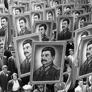 Citizen marchers carrying posters of joseph stalin at a may day parade in bucharest, romania, 1950s